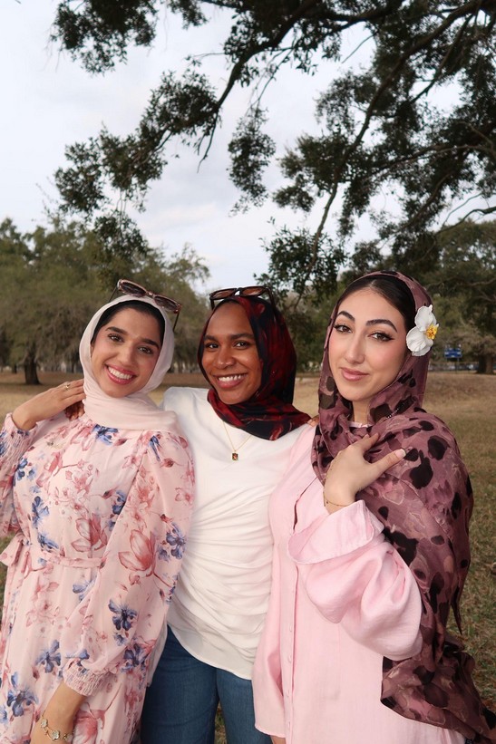 Three Ivys smiling together outdoors at a Studio Ivayah event