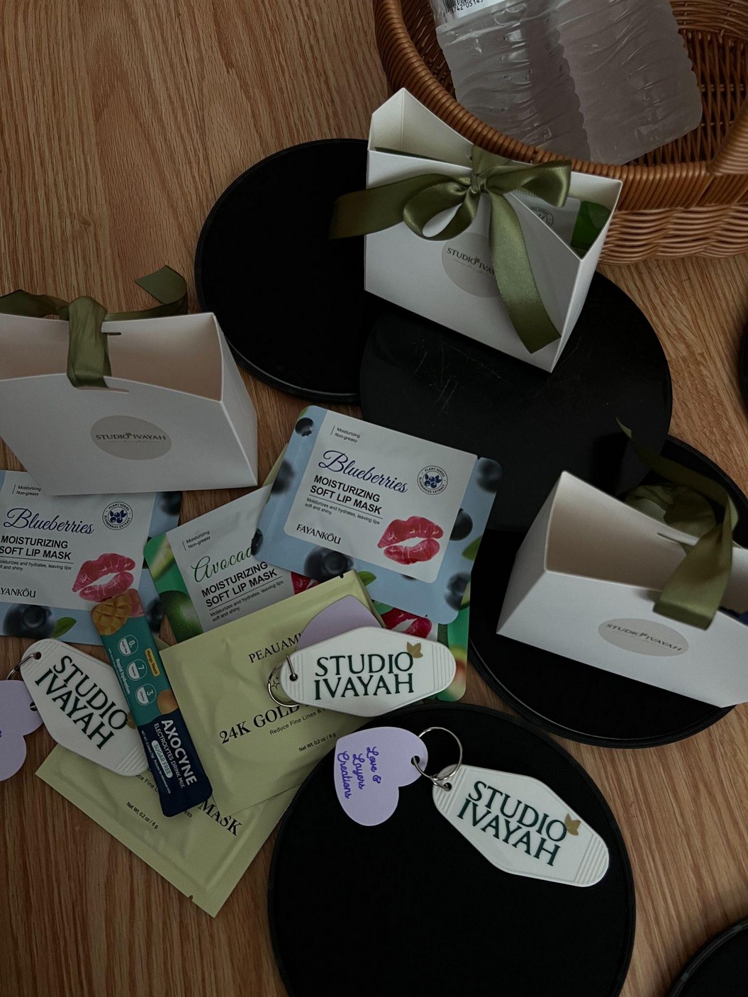 Studio Ivayah branded keychains and lip masks arranged as event favors