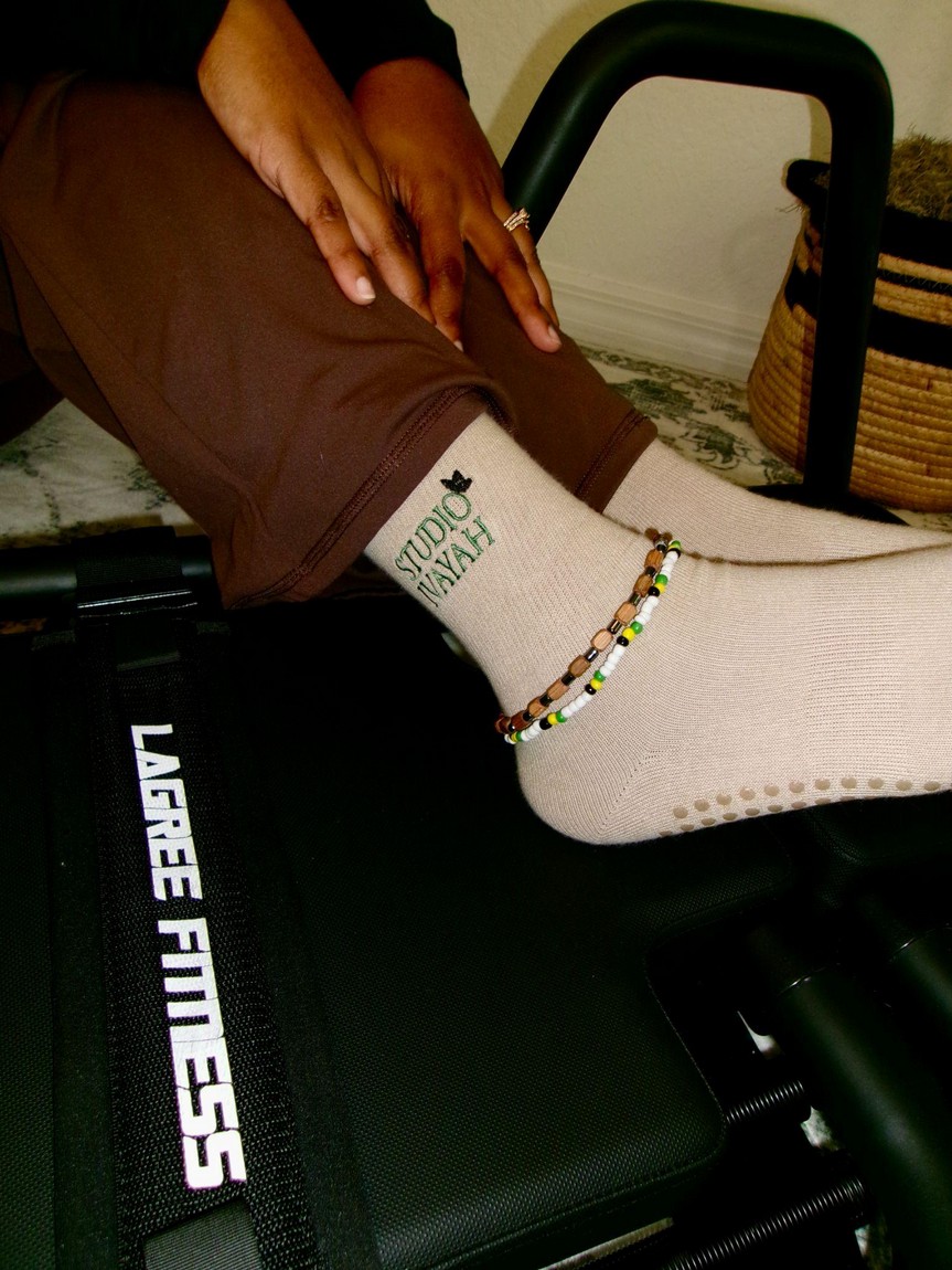 Studio Ivayah grip socks on a Lagree Fitness Microformer